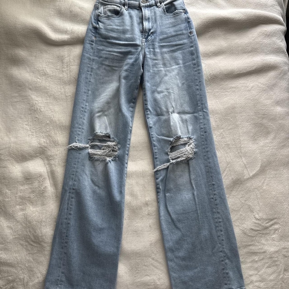 Buckle Light Wash Distressed Wide Leg Jeans